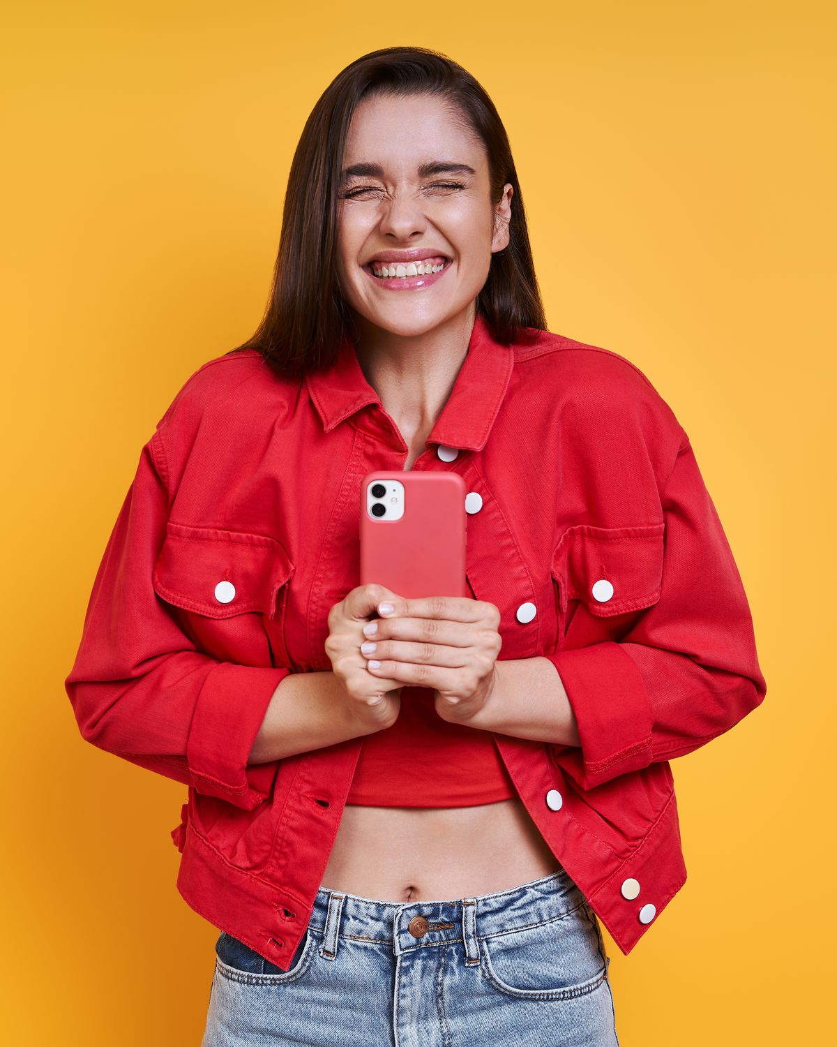 Smiling customer holding her repaired iPhone after a repair at InitEverest in Park Slope, Brooklyn